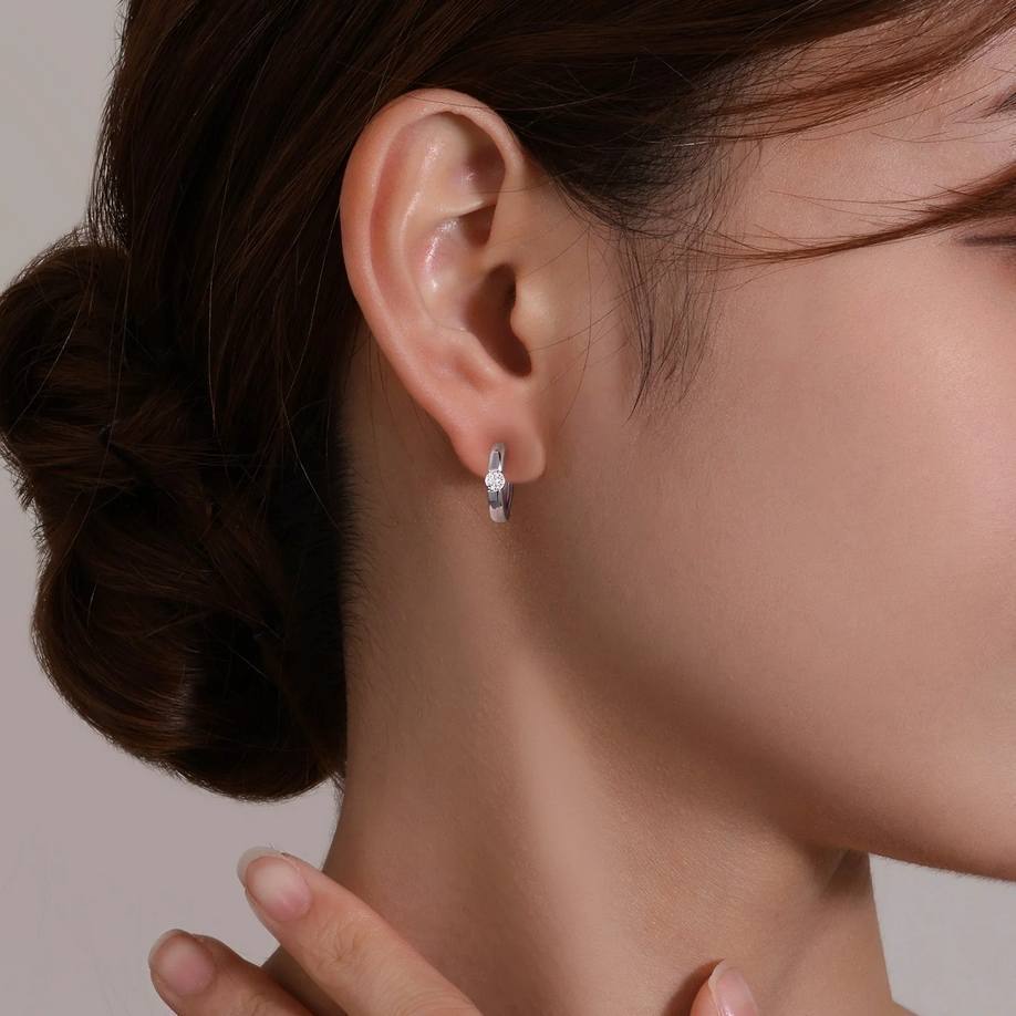 High Polish Huggie Earrings on ear