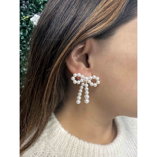 Pearl Bow Earrings on ear