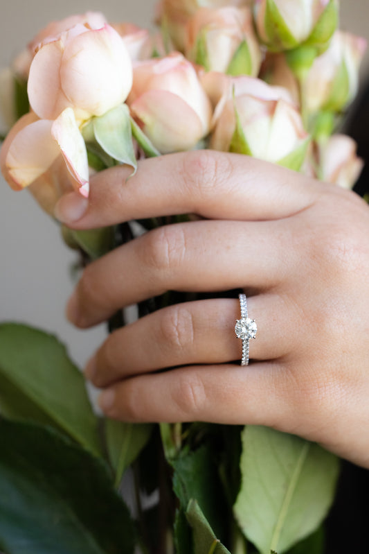 Platinum Diamond Ring on hand holding roses