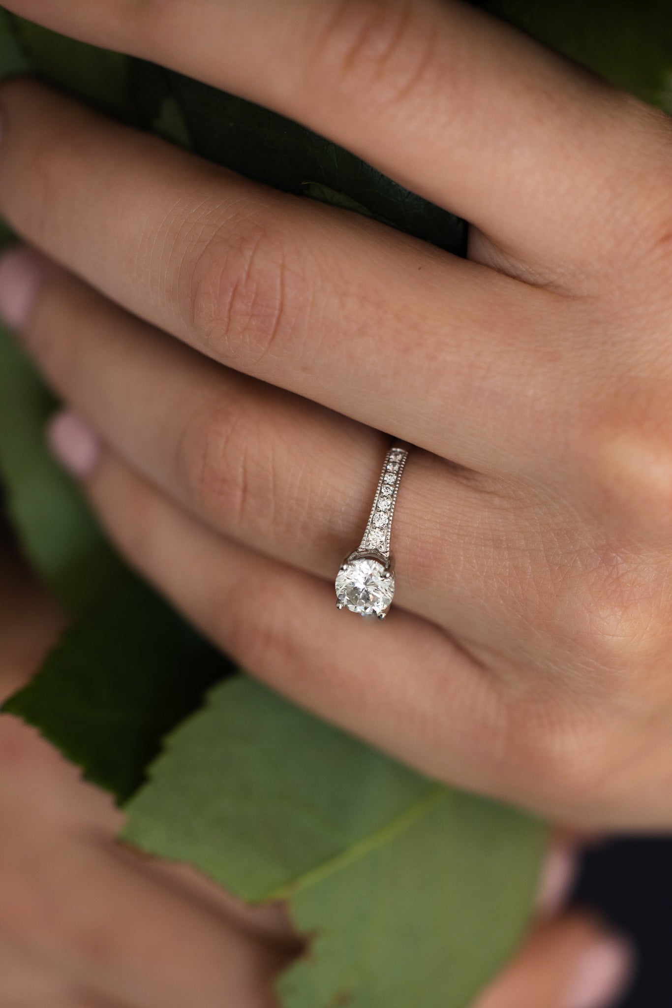 1.09 Carat Diamond Platinum Ring on hand with leaf background