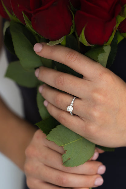 1.09 Carat Diamond Platinum Ring on hand holding roses
