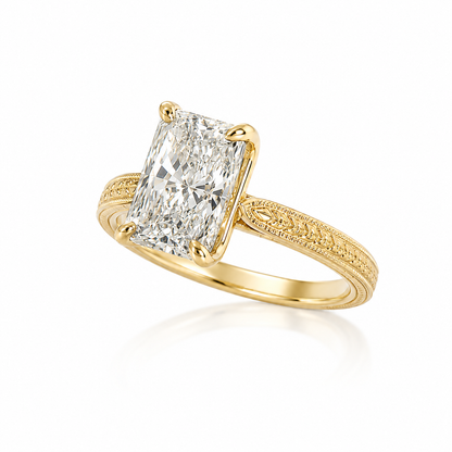 Side profile of a 14K yellow gold radiant lab-grown diamond engagement ring with a sculpted floral gallery and milgrain details.