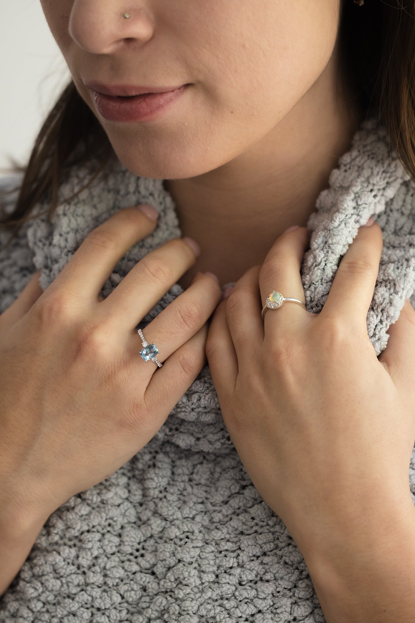 Aquamarine & Diamond Ring on lady's hand wearing grey sweater
