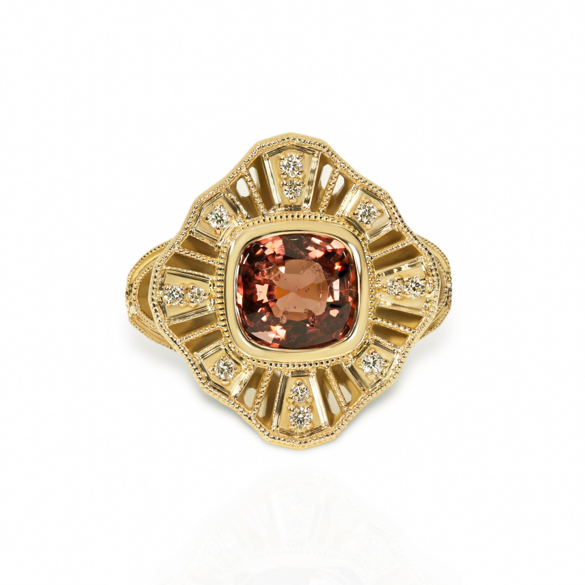 A 14kt yellow gold ring with a central spinel gemstone and accent diamonds