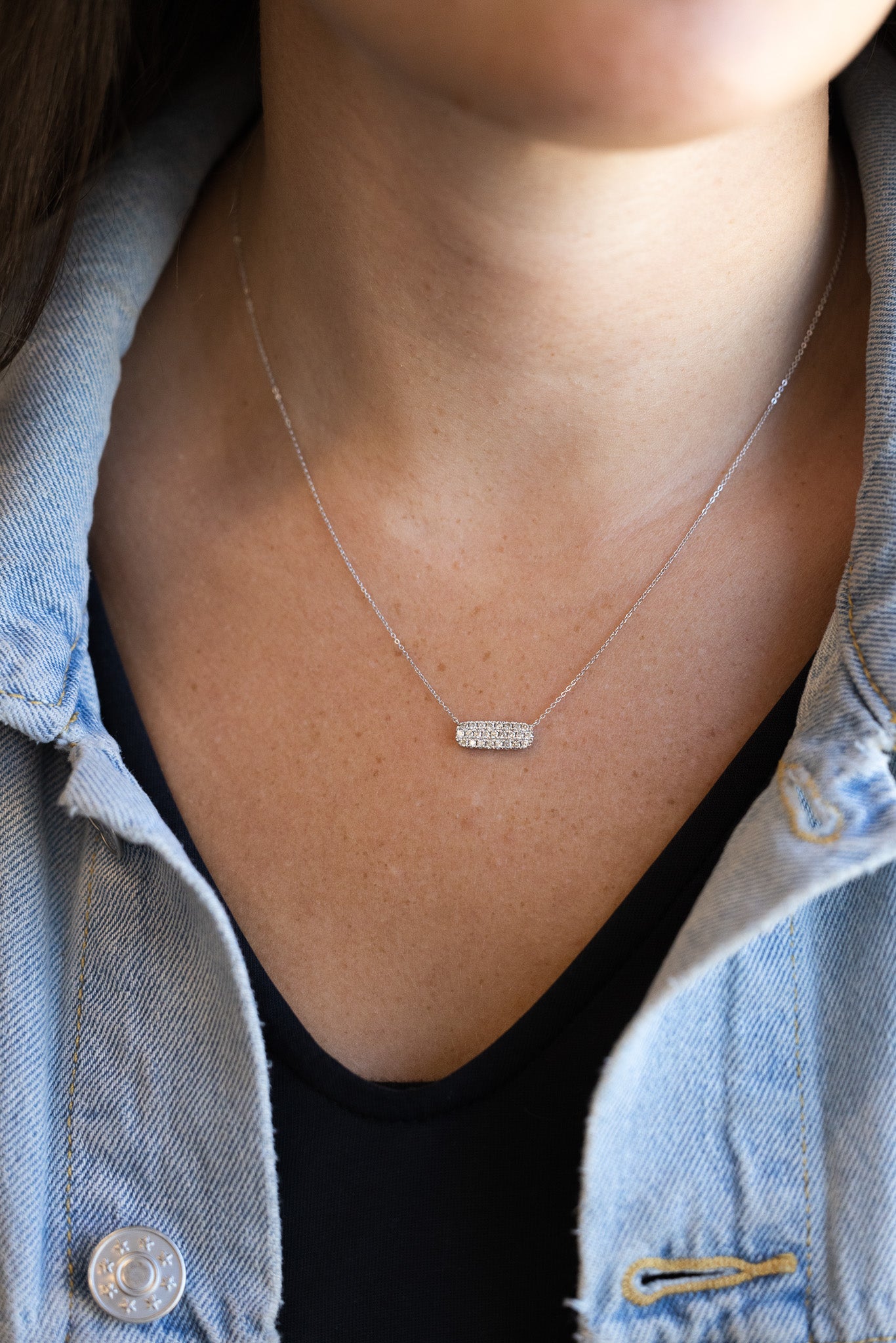 Diamond Pave' Bar Necklace on n neck with denim jacket and black shirt
