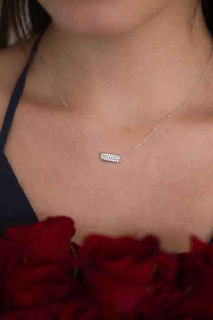 Diamond Pave' Bar Necklace on girl wearing grey dress holding roses