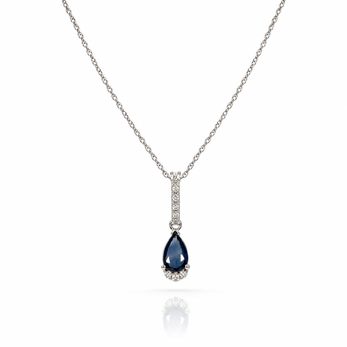 This 10k white gold necklace features a deep blue pear-shaped sapphire and delicate diamond accents along the bail and base. Creating a timeless piece that is easy to wear every day.