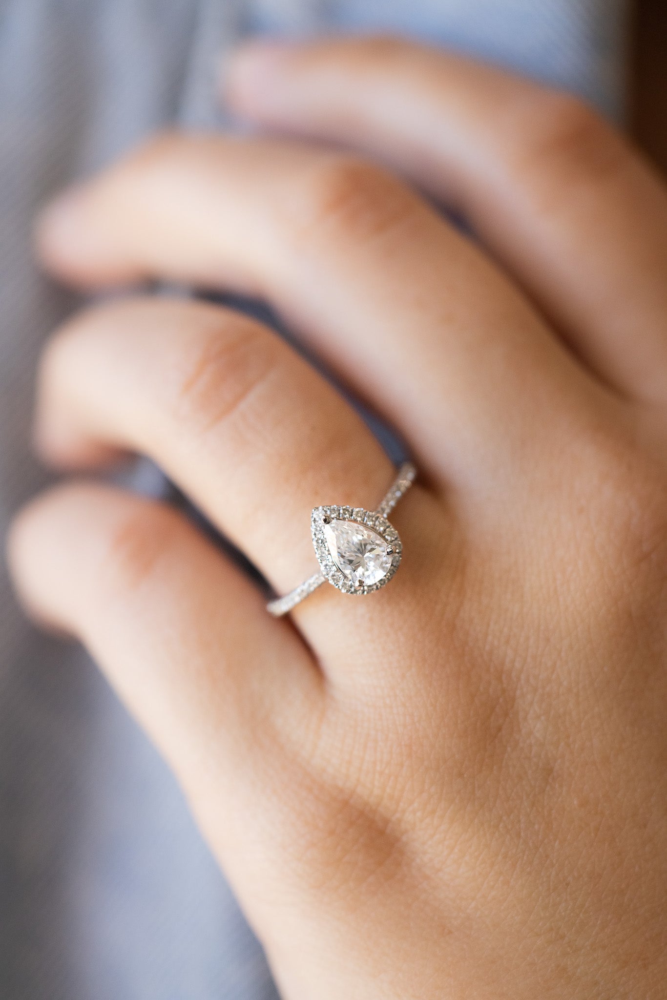 Pear Shape Halo Ring on lady's hand