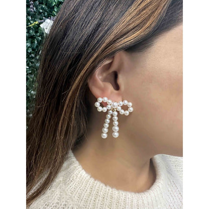 Pearl Bow Earrings on ear
