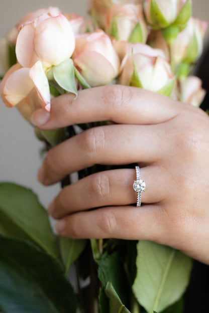 Platinum Diamond Ring on hand holding roses