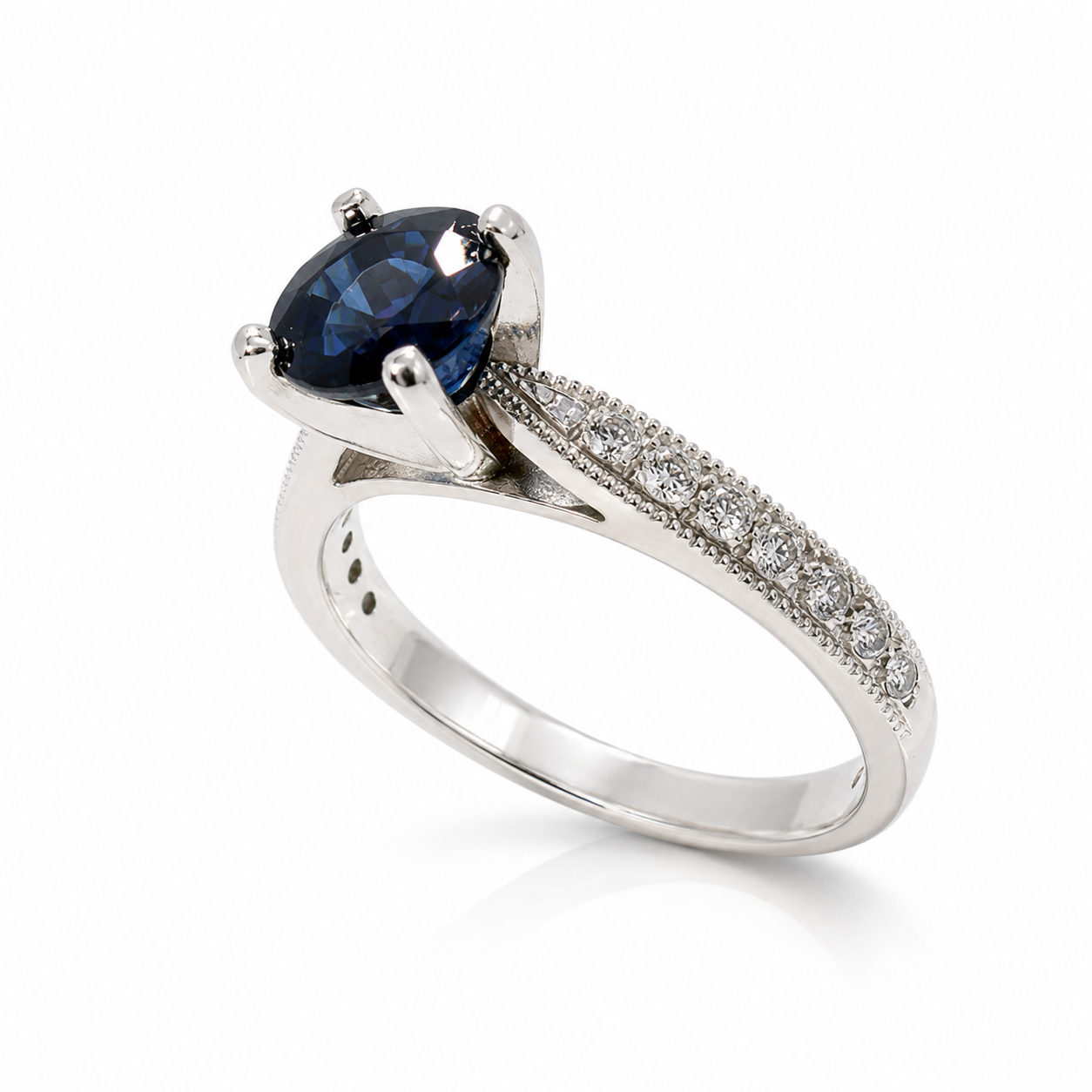 Size 7 platinum ring featuring a genuine oval blue sapphire with round diamond accents and milgrain detailing.
