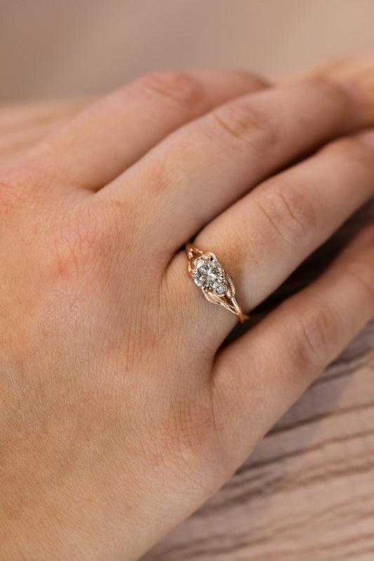 14k Rose Gold Ring with Leaf Design 
.71 Carat Round Brilliant Diamond SI2 / F
.03 Carat t.w. Accent Diamonds on lady's hand