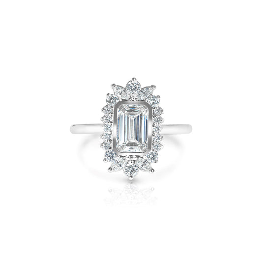 A 14k white gold engagement ring with a 1.01 carat emerald cut lab grown diamond centerpiece and smaller accent diamonds set in a white gold band.