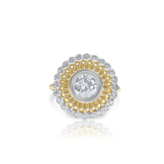 A yellow gold halo ring with a 1.12 carat center diamond and smaller accent stones.